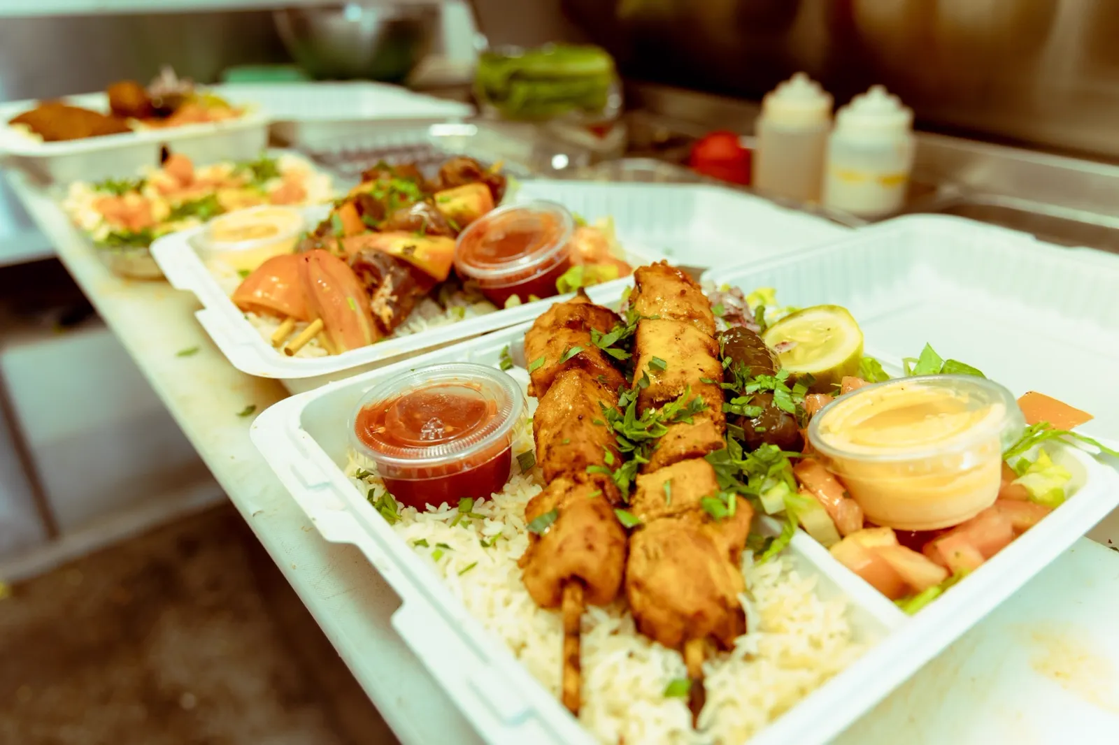 Two generous skewer plates with rice and sauces at Aladdin Grill