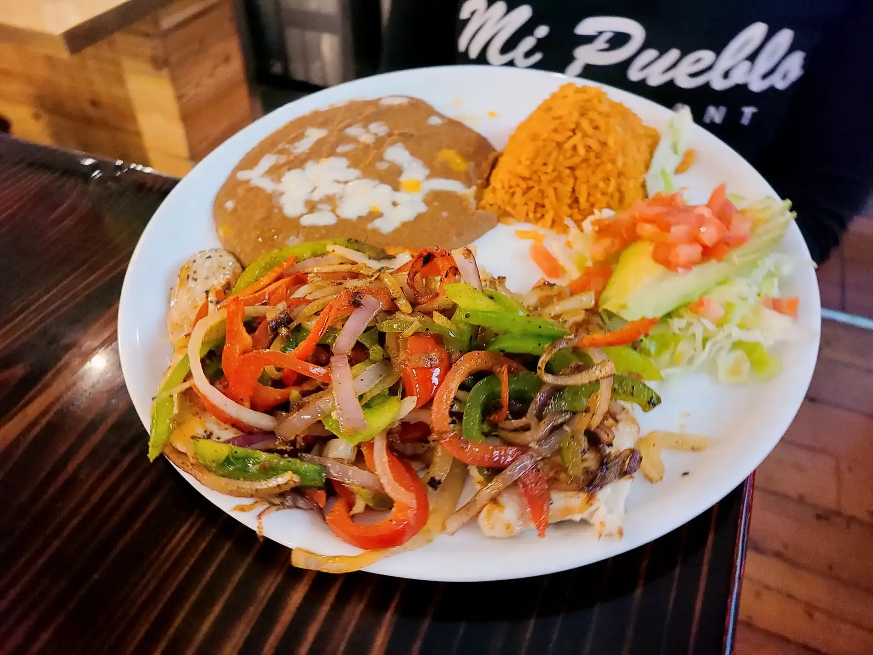 Grilled chicken with peppers, rice, beans and salad at Mi Pueblo