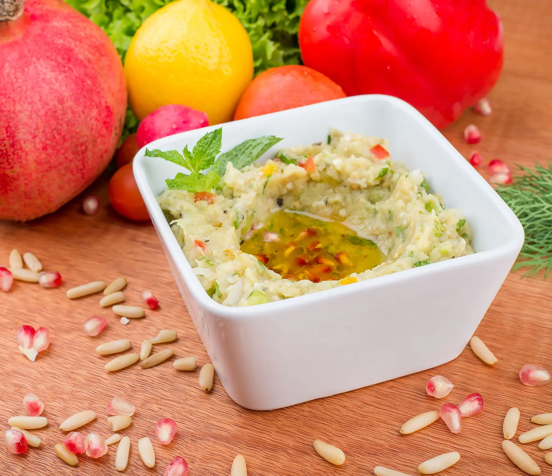 Baba ghanoush finished with olive oil, herbs and pomegranate seeds