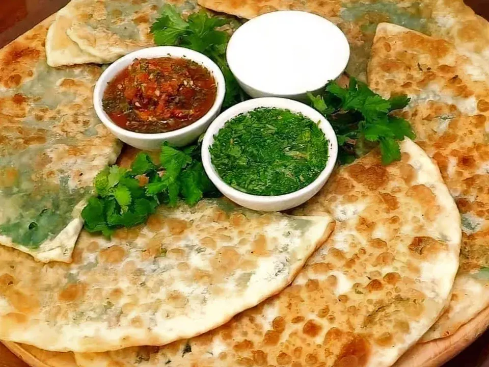 Afghan bolani flatbread with green and red sauces