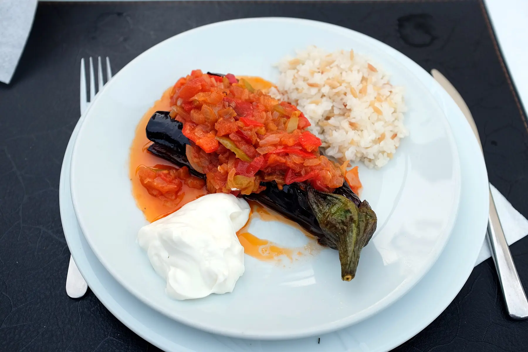Imam bayildi eggplant topped with slow-cooked tomato and onion