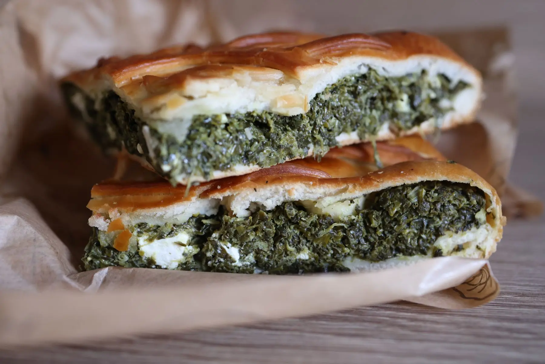 Slices of spanakopita with spinach and feta in crisp pastry