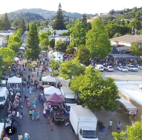 Market tents and visitors in downtown Cloverdale