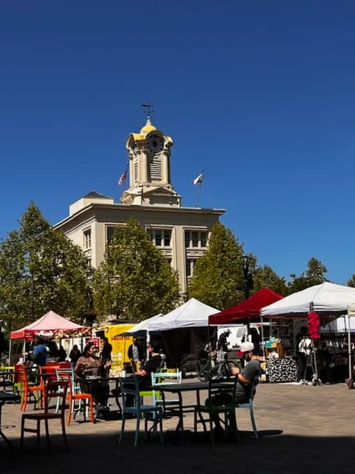 Colorful farmers market tents in a Sonoma County town square