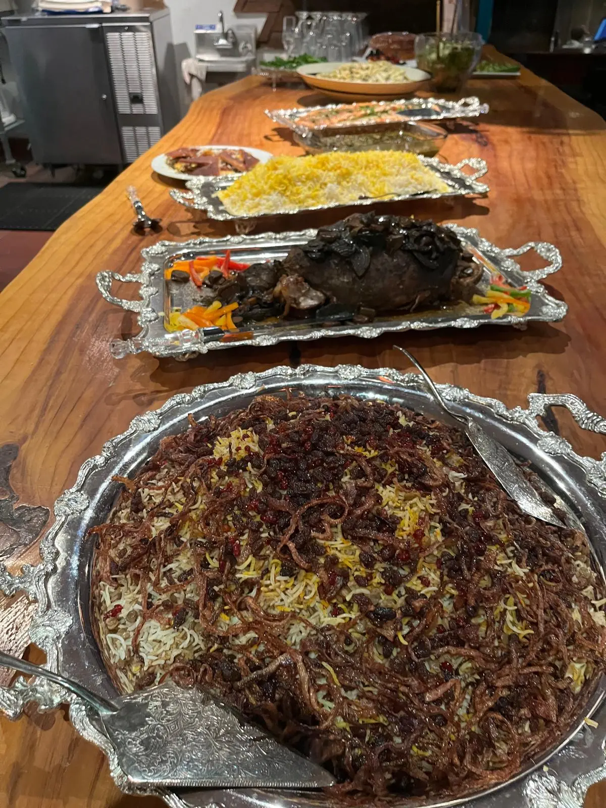 Persian lamb and jeweled rice served on silver catering platters